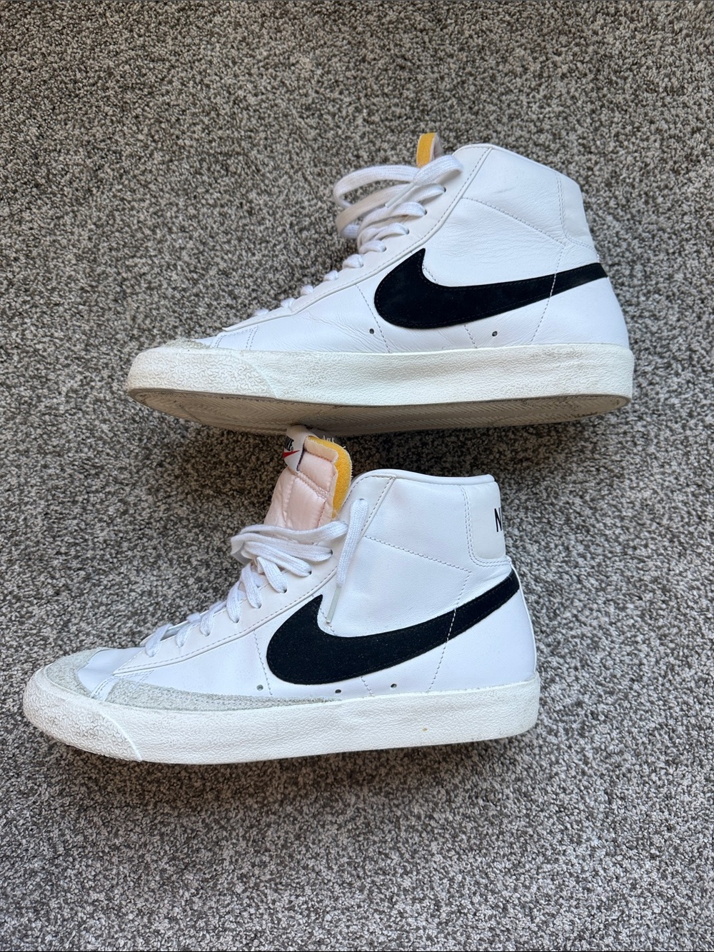 Nike White High-Top Sneakers with Black Swoosh and Yellow Tongue Tab. Mens
